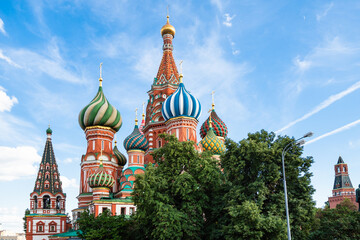 view of Saint Basil (Vasily The Blessed, Pokrovsky) cathedral near Kremlin under blue sky during city sightseeing tour on excursion bus in Moscow city in summer