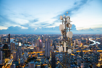 Telecommunication tower with 5G cellular network antenna on night city background - obrazy, fototapety, plakaty