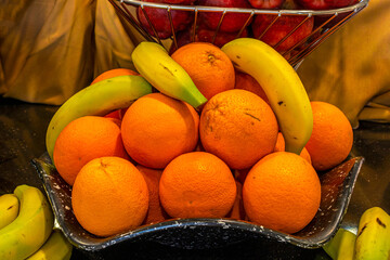 open buffet full of delicious fruits with banana, orange, grapes, peach, pear, apricot