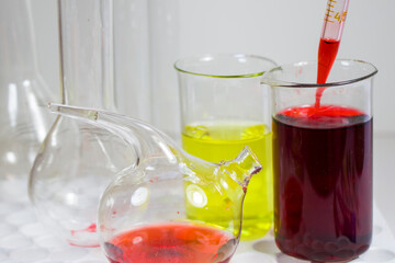 Laboratory chemical liquid elements and research diagnoses, instruments and objects in the sterile table, glassware and pipette.