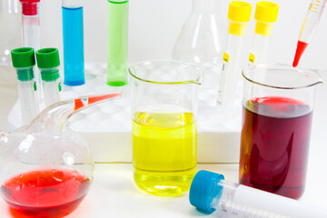 Laboratory chemical liquid elements and research diagnoses, instruments and objects in the sterile table, glassware and pipette.