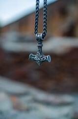 Thor's hammer as a symbol of war against the backdrop of destruction.