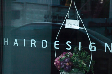 Hairdesign word advertisement on a window glass