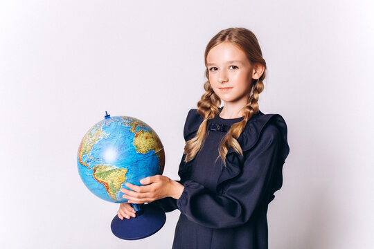 Back to school. Cute adorable caucasian blondie girl with glode in school uniform on white background