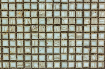 Old square background mosaic, ceramics. Abstract pixels. Ceramic tiles. Texture for facing the walls of the pool, bathroom, kitchen, tiled floor. Multi-colored mosaic tile wall. Square mosaic tile.