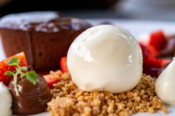 Tasty dessert, hot chocolate cake and vanilla ice cream with fresh strawberry
