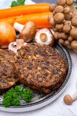 Tasty vegetarian food, burgers with champignons mushrooms, buna shimeji, carrot and onion