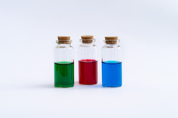 Three closed vials with colored contents on a white background.