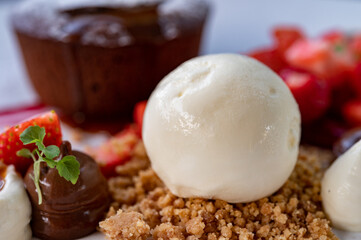 Tasty dessert, hot chocolate cake and vanilla ice cream with fresh strawberry