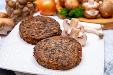 Tasty vegetarian food, burgers with champignons mushrooms, buna shimeji, carrot and onion