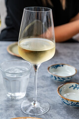 Drinking cold white wine with friends on outdoor terrace, summer vacation