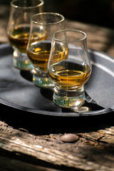 Tasting of different Scotch whiskies on outdoor terrace, dram of whiskey