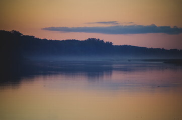 Fototapeta premium Evening twilight over a foggy lake.