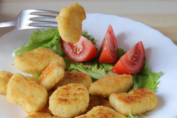 delicious little fried meat cutlets with fresh tomatoes
