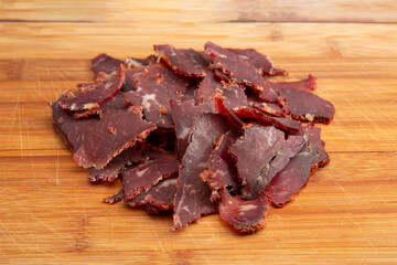 Close up shot of the Turkish traditional pastirma (pastrami) on wooden chopping board with copy space for text