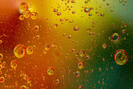 Abstract colorful background with oil drops and waves on water surface