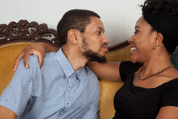 Romantic Black couple sitting on a couch