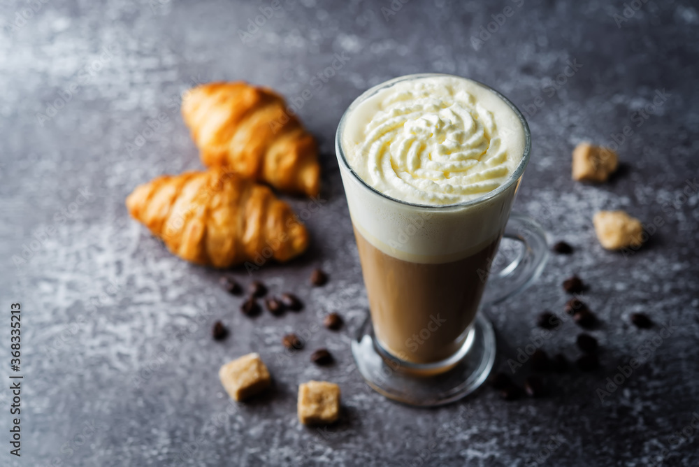 Wall mural Coffee with whipped cream in a glass with coffee beans