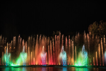 Musical multimedia fountain with colorful lights at night. Ukraine, Vinnitsa