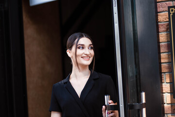 Portrait of a girl in the city. Girl in a black dress. Young beautiful woman. Makeup. Pretty Girl.