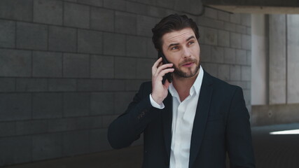 Businessman talking on cellphone at street. Business man calling on phone