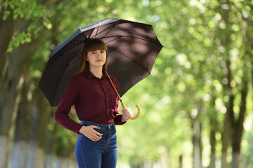 Girl with an open black umbrella, close-up.