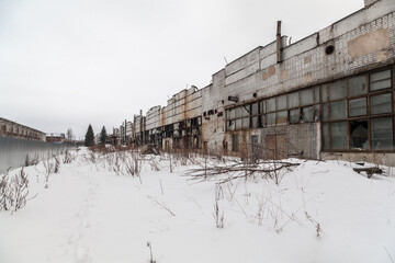Fototapeta na wymiar Abandoned soviet factory facade in winter time