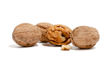 Several whole walnuts and one open on a white background
