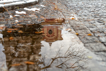 Reflection on water puddle of colorful old houses in historic centre of Praha Architectural style, colorful background