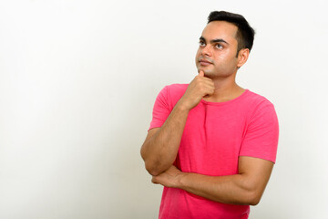 Portrait of young handsome Indian man against white background