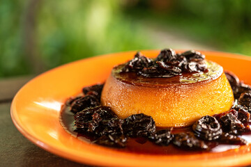Brazilian gastronomy. Milk pudding with plum sauce.