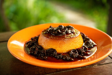 Brazilian gastronomy. Milk pudding with plum sauce.