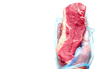 Butcher holding one fresh juicy striploin steak in his hand in blue glove. White background. Meat industry product.