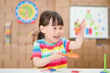 young  girl  play magical magnet experiments at home for homeschooling