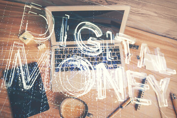 Blockchain theme hologram drawings over computer on the desktop background. Top view. Multi exposure. Concept of cryptoeconomy.