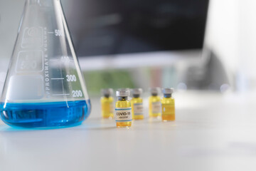 A blue and yellow chemical liquids into test tubes in clean laboratory room.