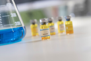 A blue and yellow chemical liquids into test tubes in clean laboratory room.