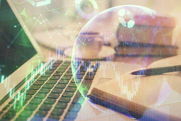 Double exposure of financial chart drawing and desktop with coffee and items on table background. Concept of forex market trading