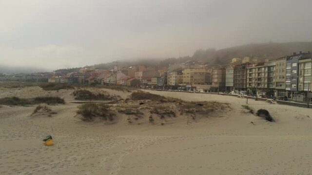 Beach wih fog in coastal village. Galicia,Spain. Aerial Drone Footage