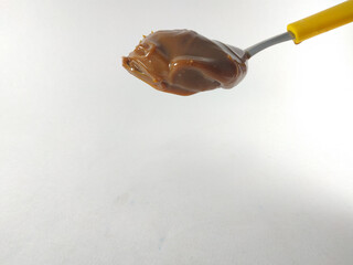 peanut butter on a yellow spoon