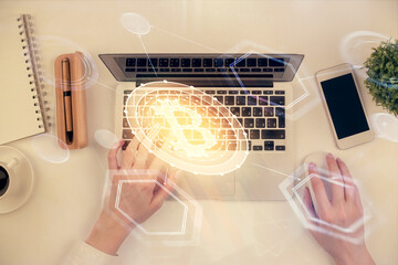 Double exposure of woman hands working on computer and blockchain theme hologram drawing. Top View. bitcoin cryptocurrency concept.