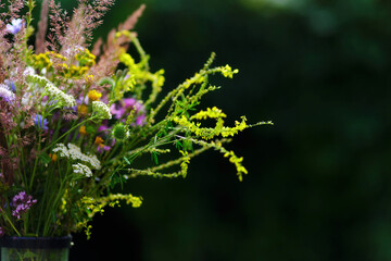 Bouquet of wild flowers in vase in a garden