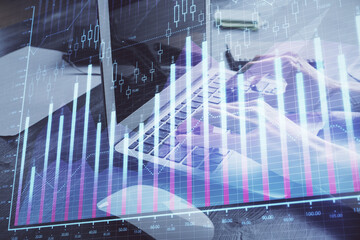Double exposure of woman hands typing on computer and forex chart hologram drawing. Stock market invest concept.