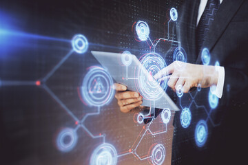 Double exposure of man's hand holding and using a digital device and data theme hologram drawing. Technology concept.