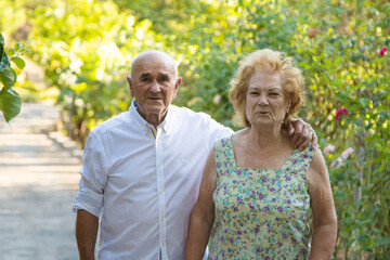 senior couple walking embraced outdoors
