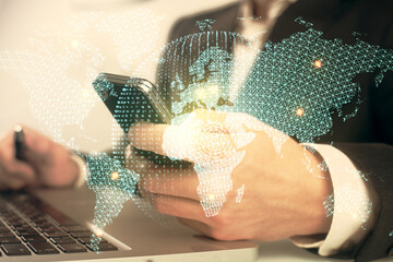 Double exposure of man's hands holding and using a phone and international business theme drawing.