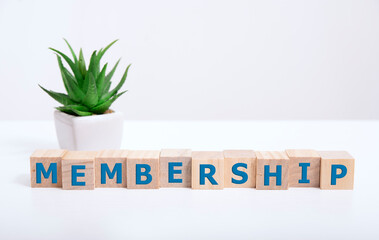 focus on wooden blocks with letters making Membership text. Concept image.