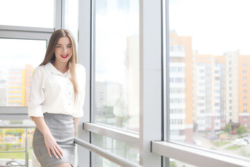 Fototapeta premium young female student sitting in the office solving problems