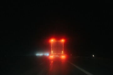 tail light of truck at night during rain
