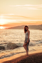 Fototapeta na wymiar Tropical Portrait of Young Beautiful woman on the beach on the sea ocean in dress 